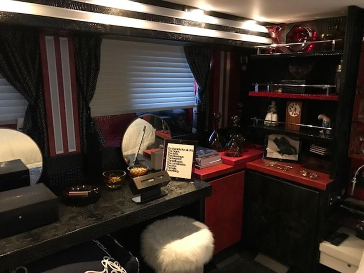 a room with a desk and a chair aboard KISSES Yacht for Sale