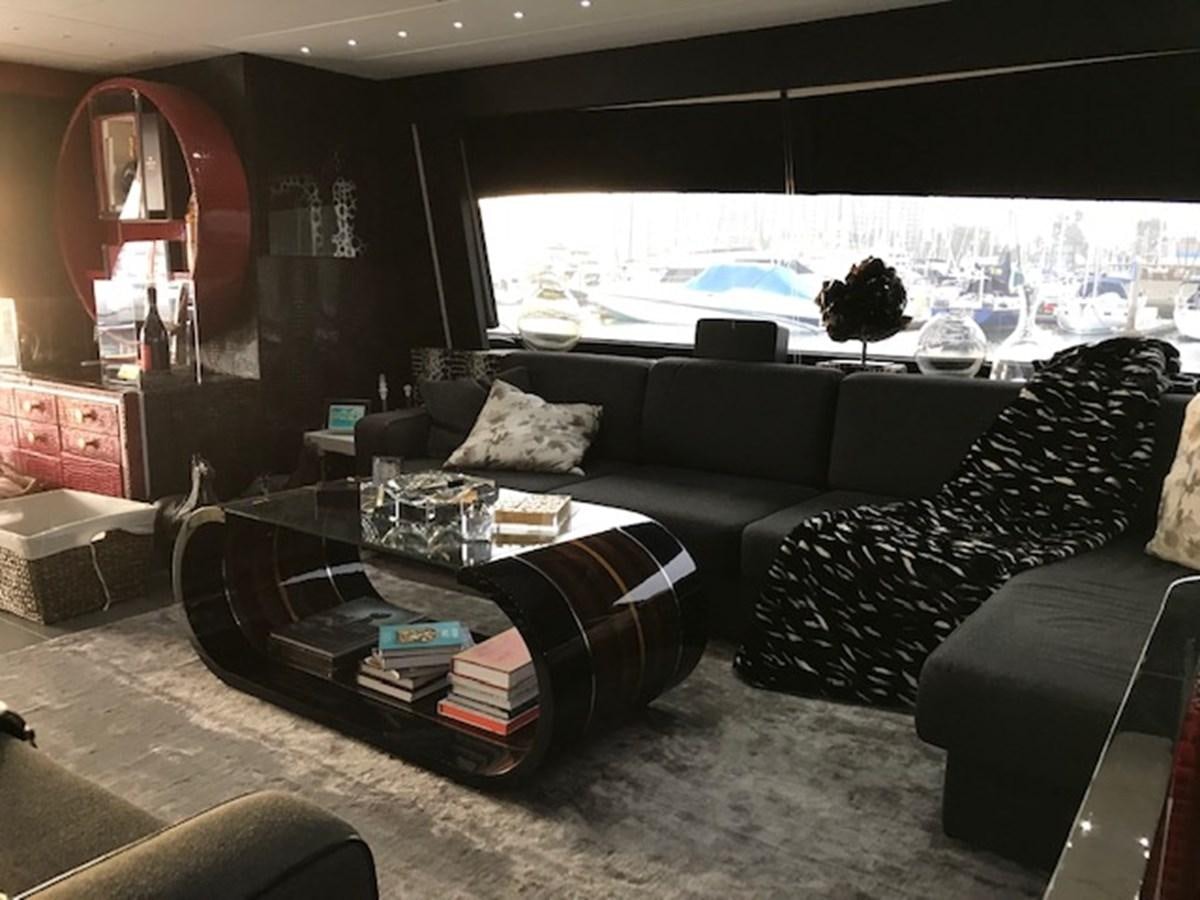 a living room with a couch and a table aboard KISSES Yacht for Sale