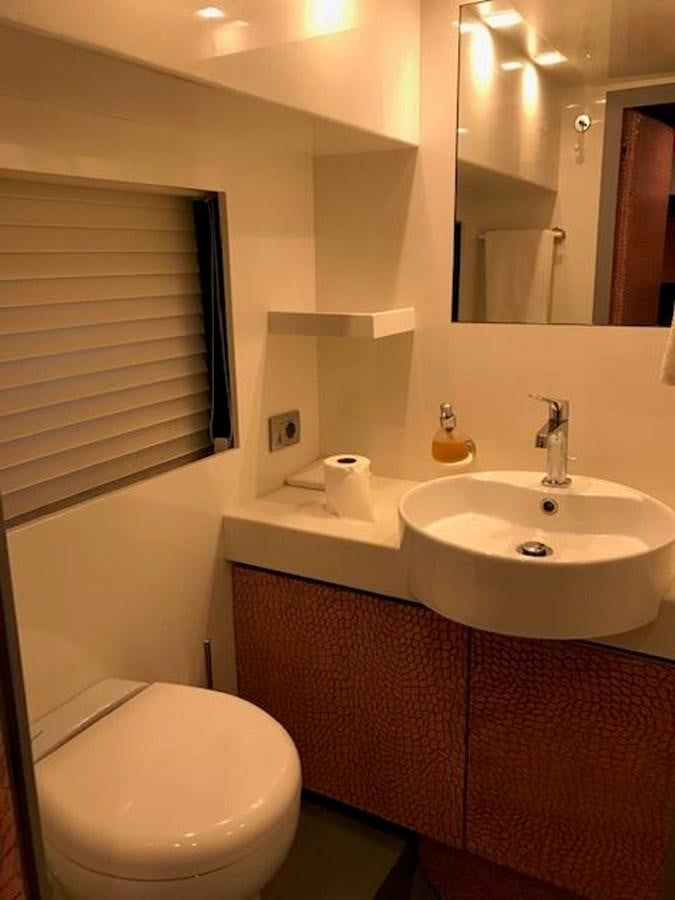 a bathroom with a toilet and sink aboard KISSES Yacht for Sale