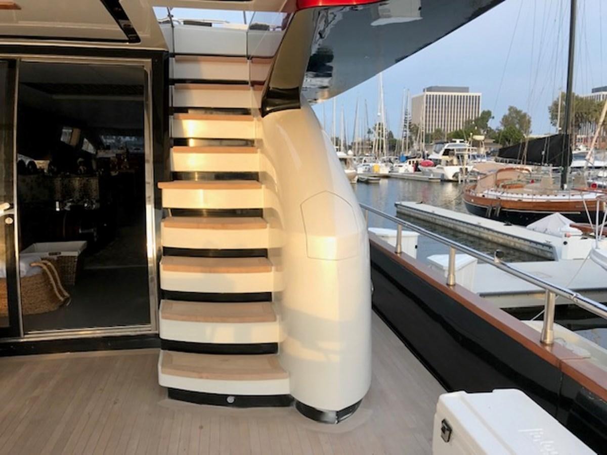 a staircase with a glass door leading to a marina with boats aboard KISSES Yacht for Sale