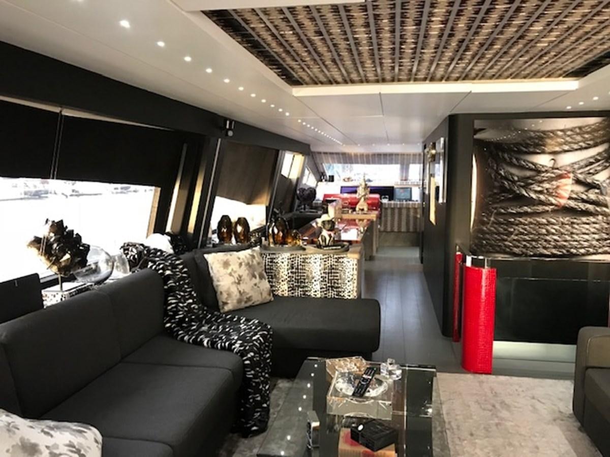 a room with couches and a table aboard KISSES Yacht for Sale