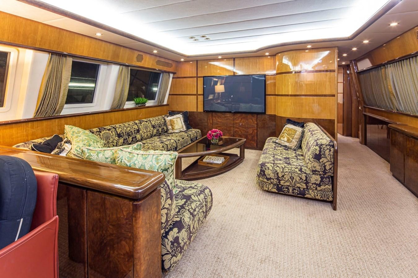 a living room with a couch and a coffee table aboard WILD WAVES Yacht for Sale