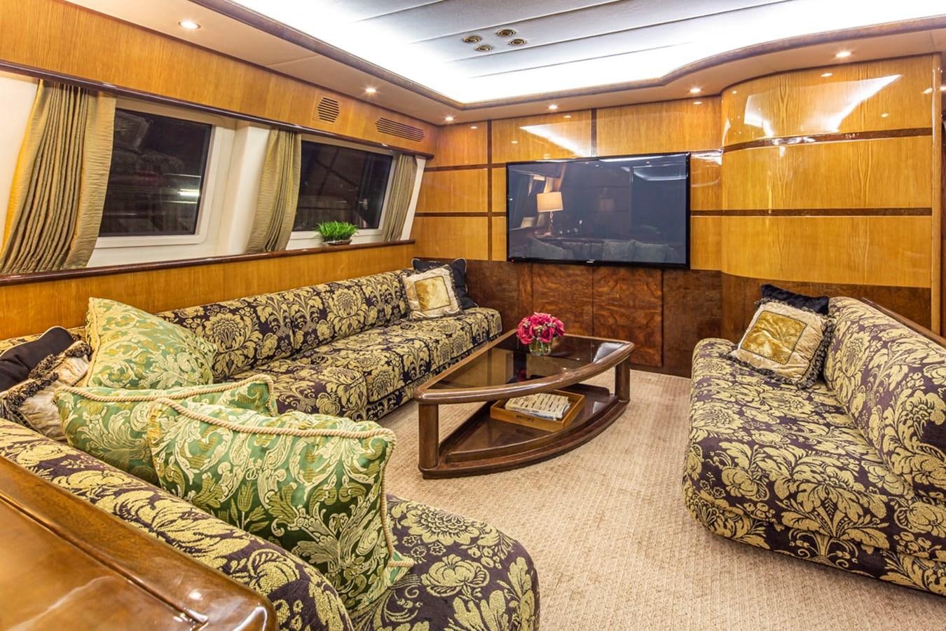 a living room with a couch and a tv aboard WILD WAVES Yacht for Sale