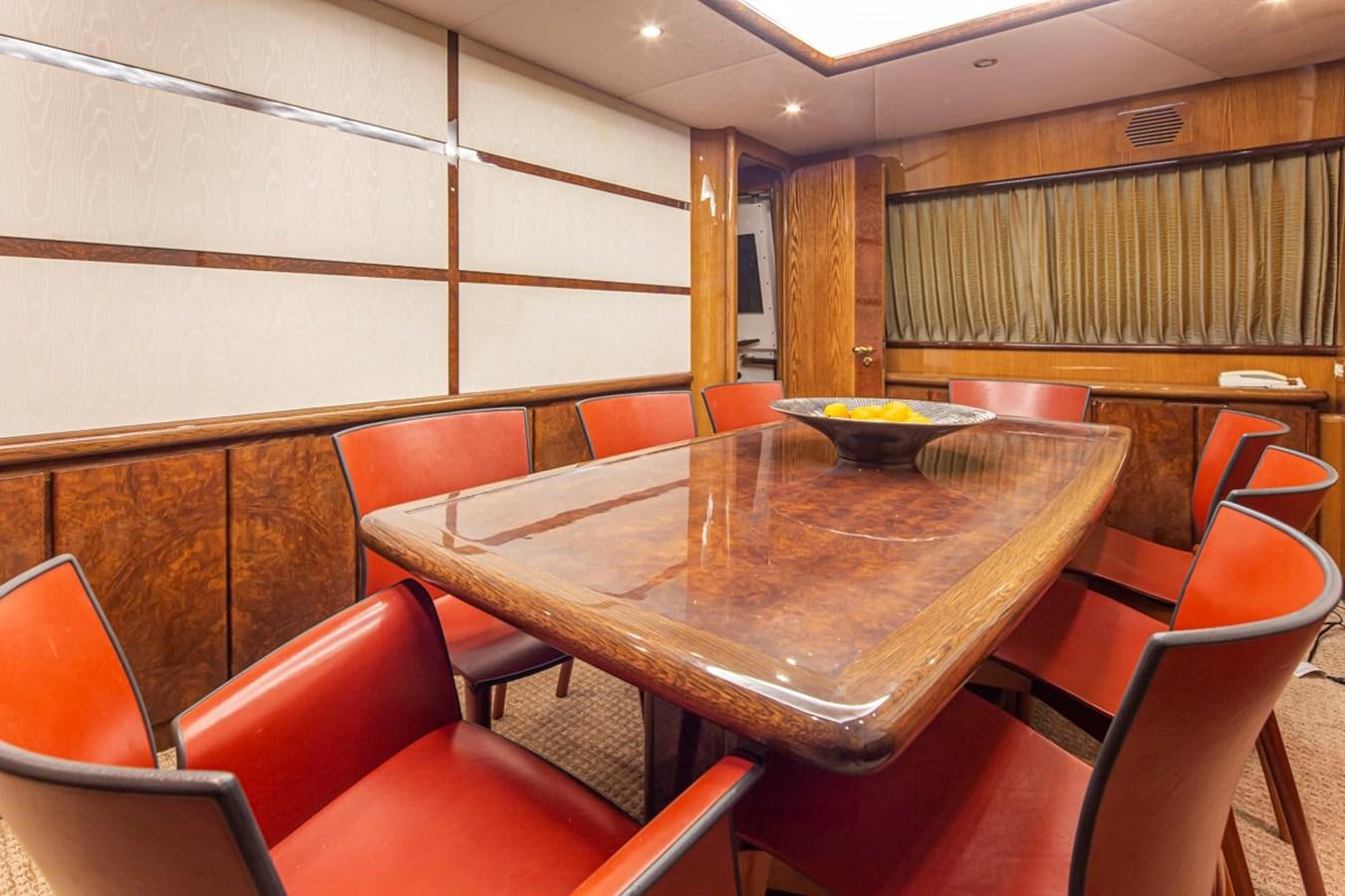 a room with a table and chairs aboard WILD WAVES Yacht for Sale