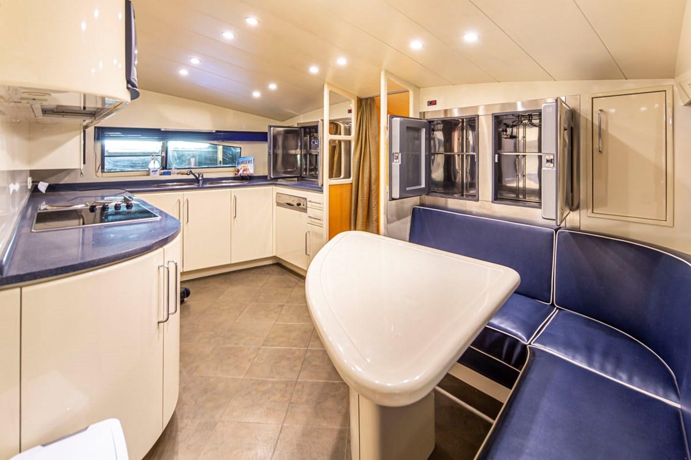 a large kitchen with a large blue countertop aboard WILD WAVES Yacht for Sale
