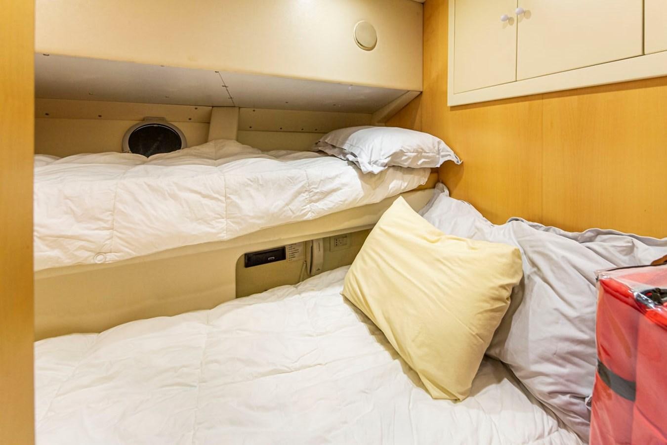 a room with white sheets aboard WILD WAVES Yacht for Sale