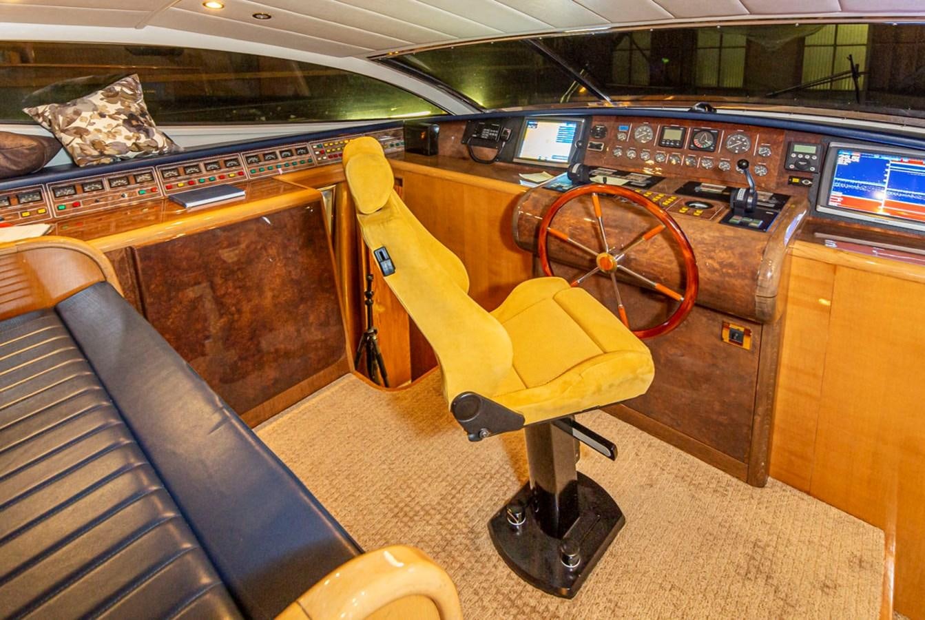 a yellow chair in a room aboard WILD WAVES Yacht for Sale