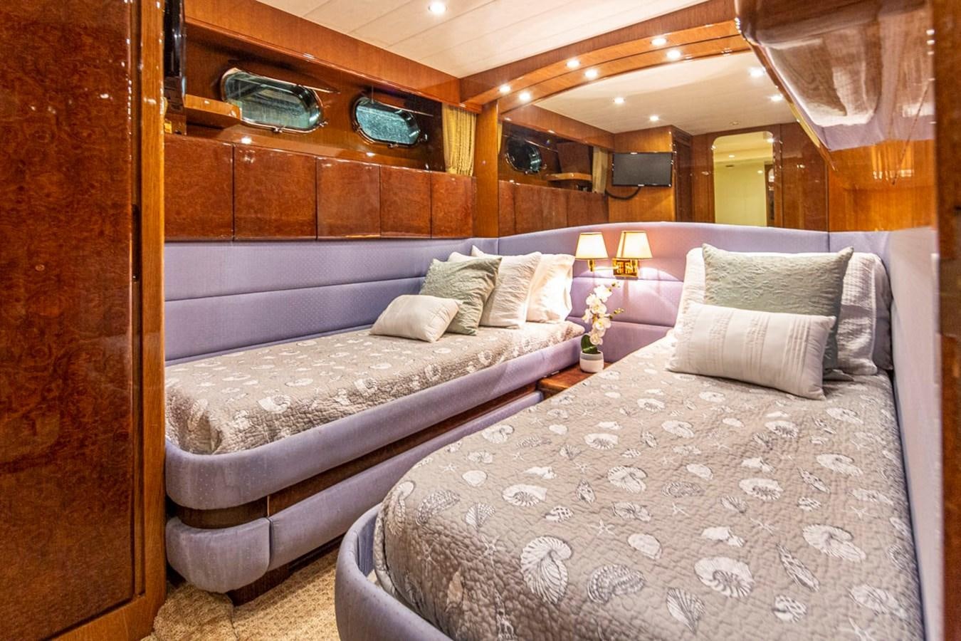a room with a bed and a window aboard WILD WAVES Yacht for Sale