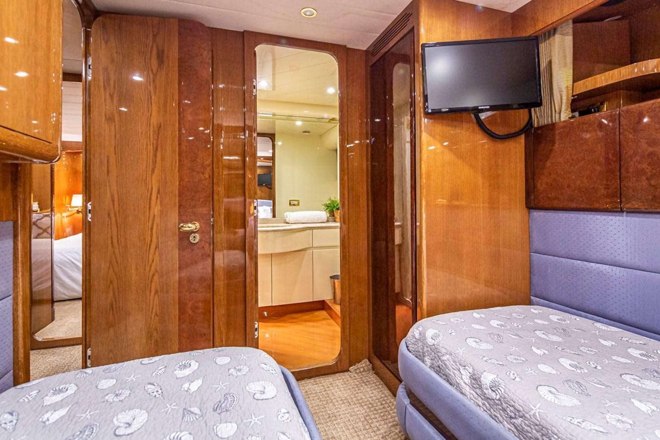 a room with a bed and a television aboard WILD WAVES Yacht for Sale