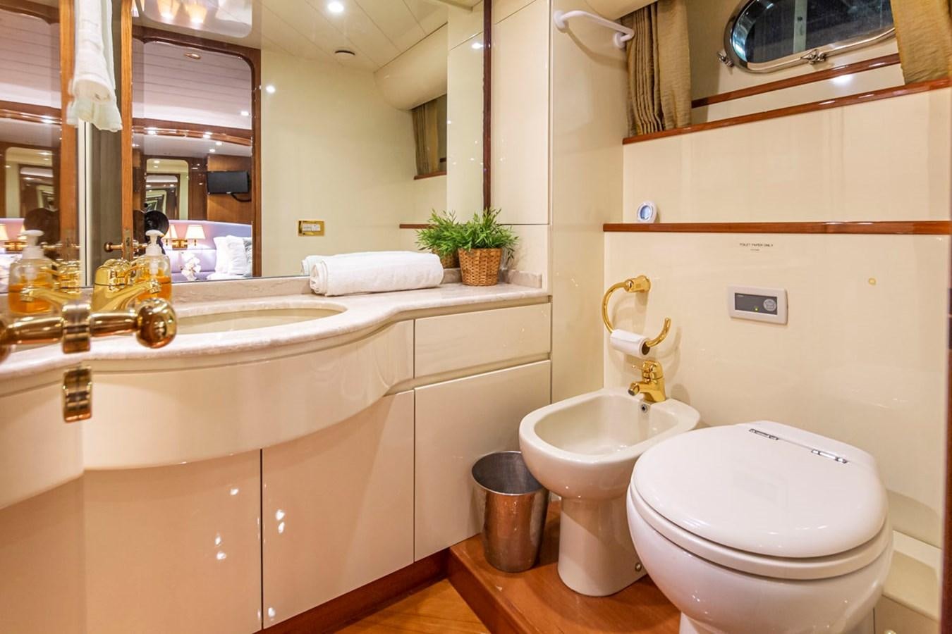 a bathroom with a toilet and sink aboard WILD WAVES Yacht for Sale