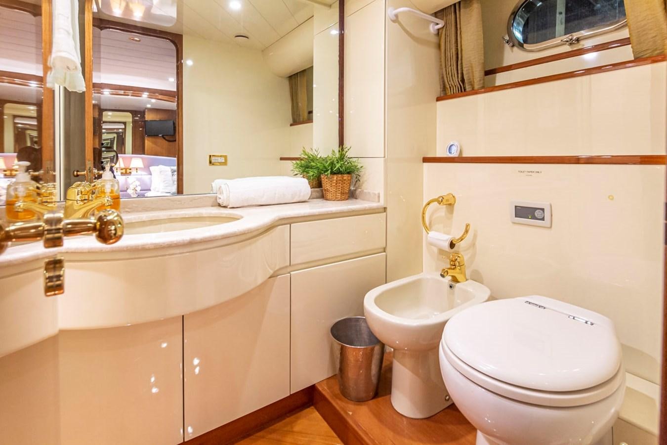 a bathroom with a toilet and sink aboard WILD WAVES Yacht for Sale