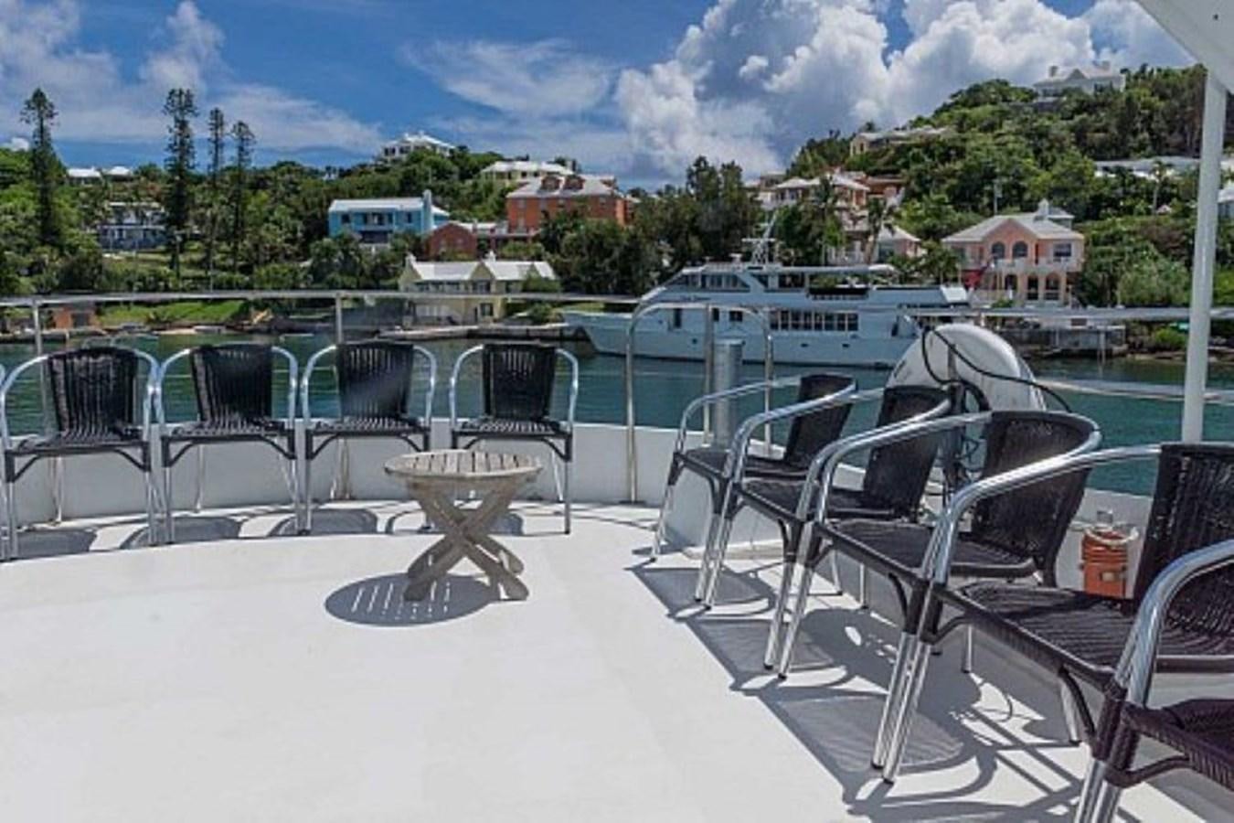 a deck with chairs and tables aboard LADY CHARLOTTE Yacht for Sale