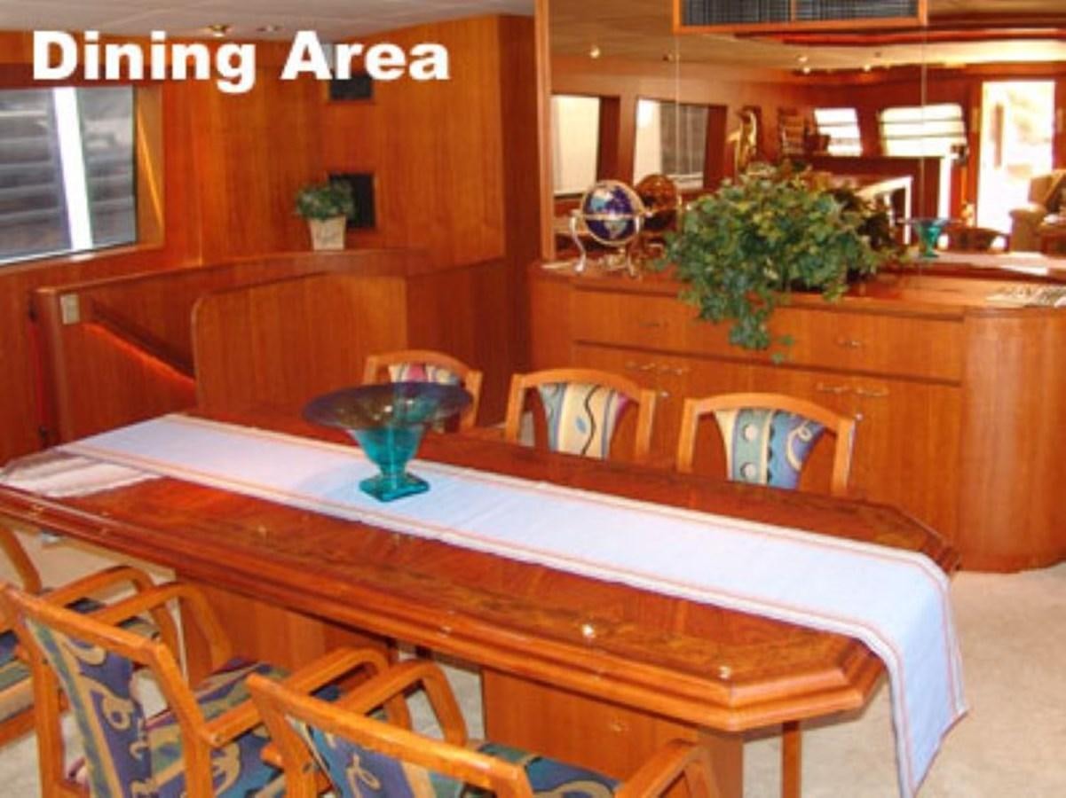 a room with a table and chairs aboard LADY CHARLOTTE Yacht for Sale