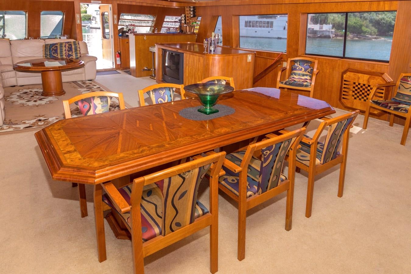 a wooden table with chairs around it aboard LADY CHARLOTTE Yacht for Sale
