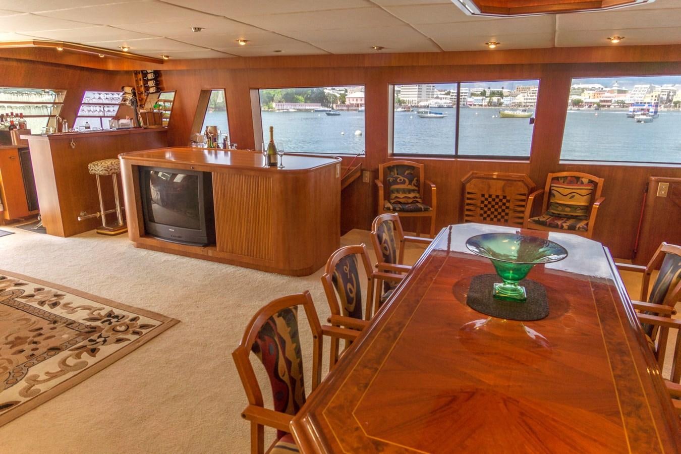 a room with a table and chairs aboard LADY CHARLOTTE Yacht for Sale