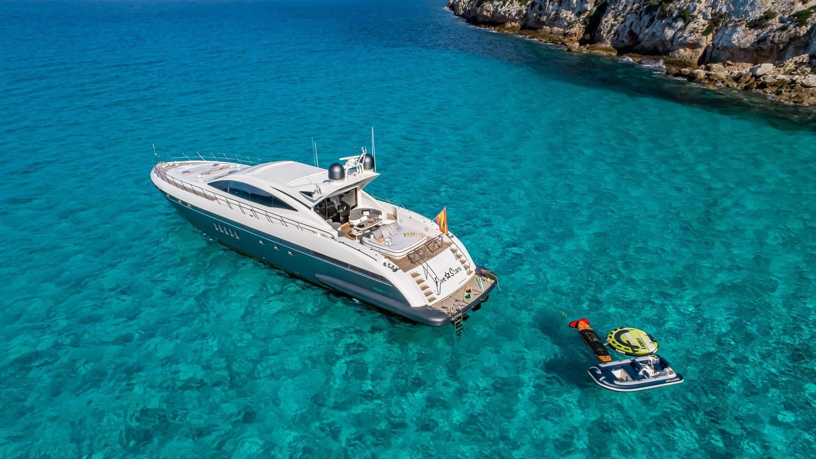 a boat and a motorboat in the water aboard FIVE STARS Yacht for Sale