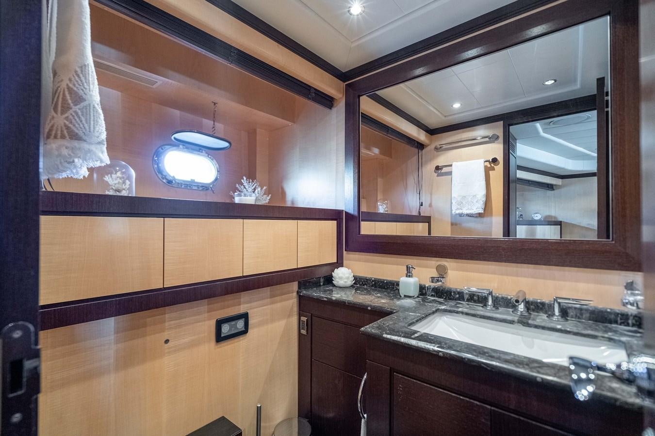 a bathroom with a large mirror aboard FIVE STARS Yacht for Sale