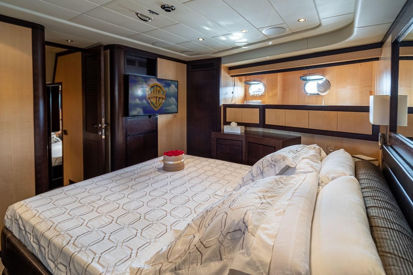 a bed with white sheets aboard FIVE STARS Yacht for Sale