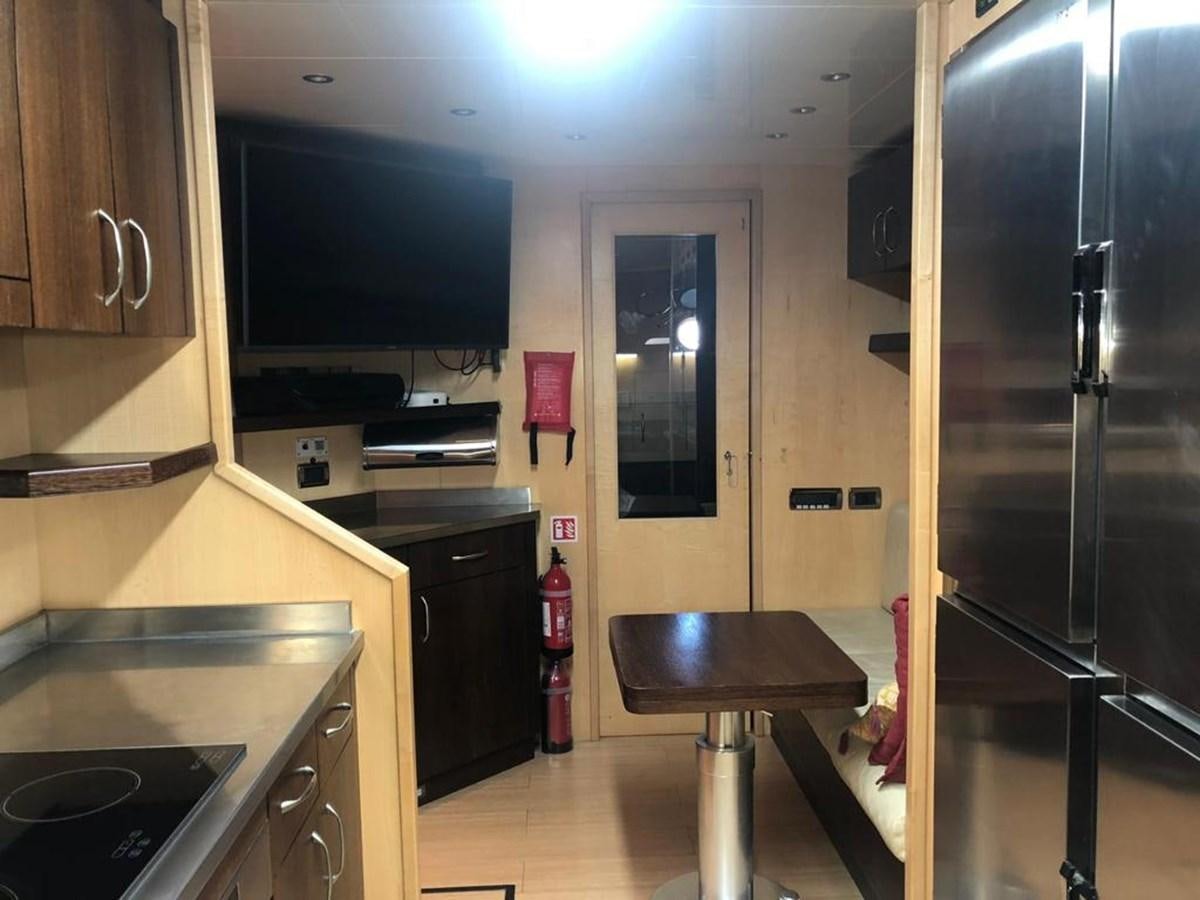 a kitchen with a stainless steel refrigerator aboard FIVE STARS Yacht for Sale