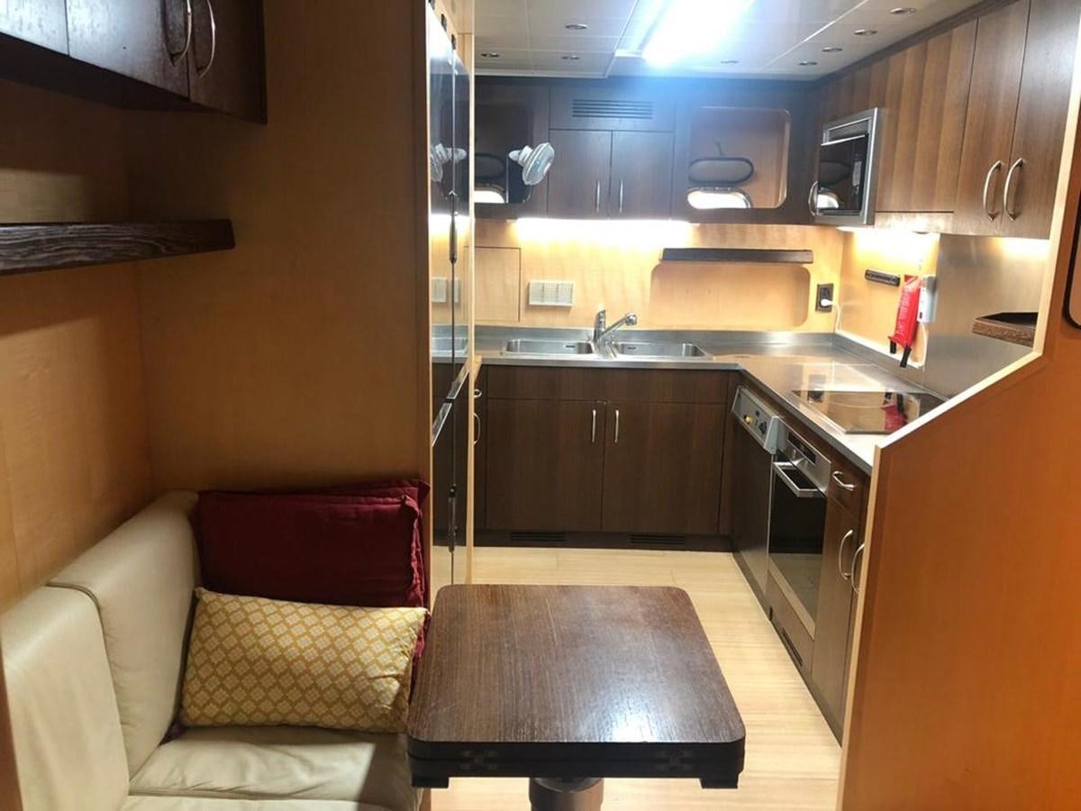 a kitchen with a sink and a couch aboard FIVE STARS Yacht for Sale