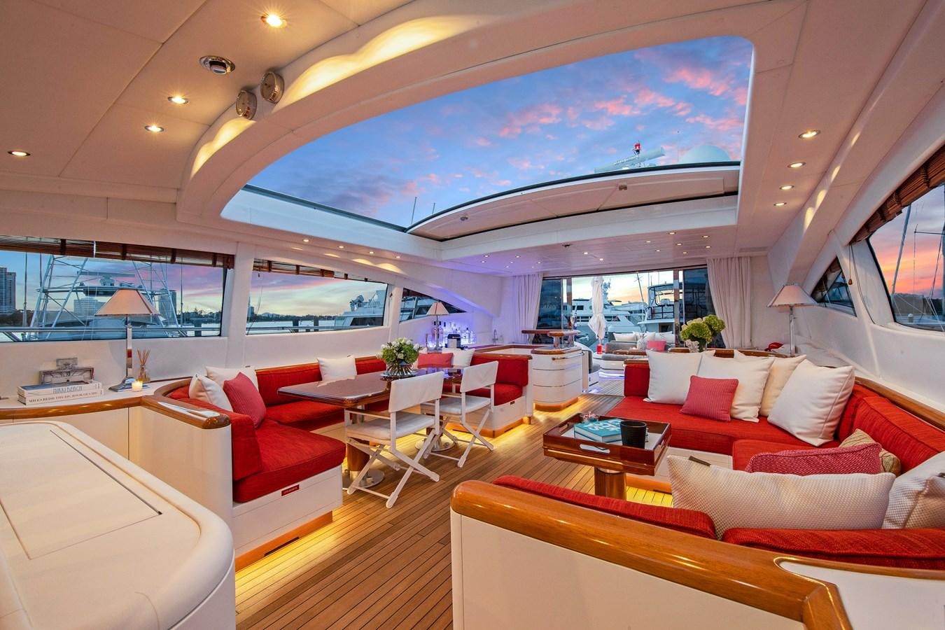 a room with a couch and a table and chairs aboard VANISH Yacht for Sale