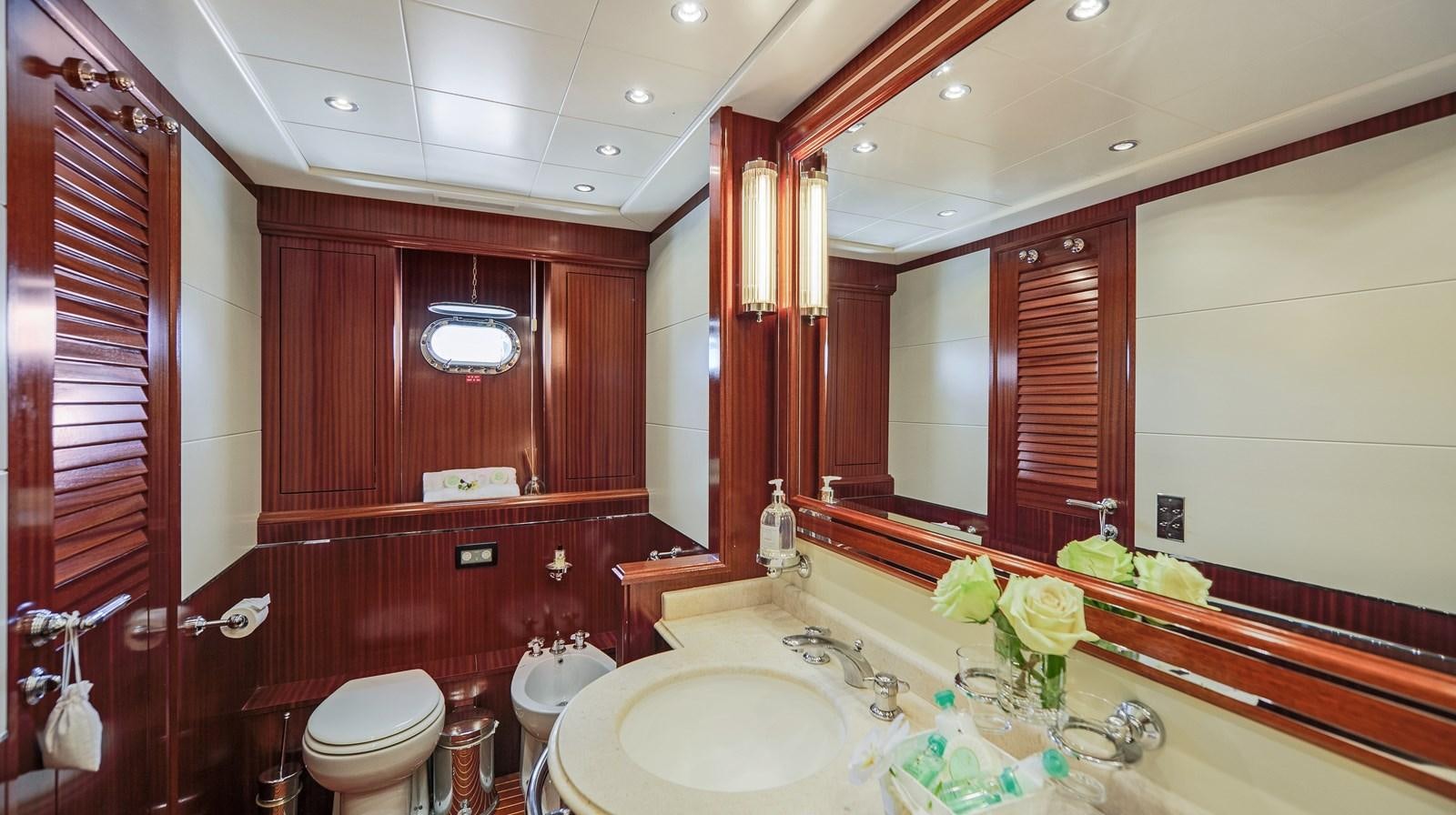 a bathroom with a tub sink and toilet aboard VANISH Yacht for Sale
