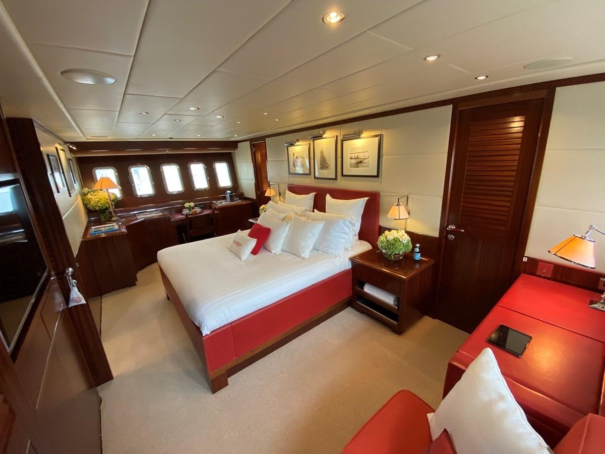 a hotel room with a bed and a desk aboard VANISH Yacht for Sale