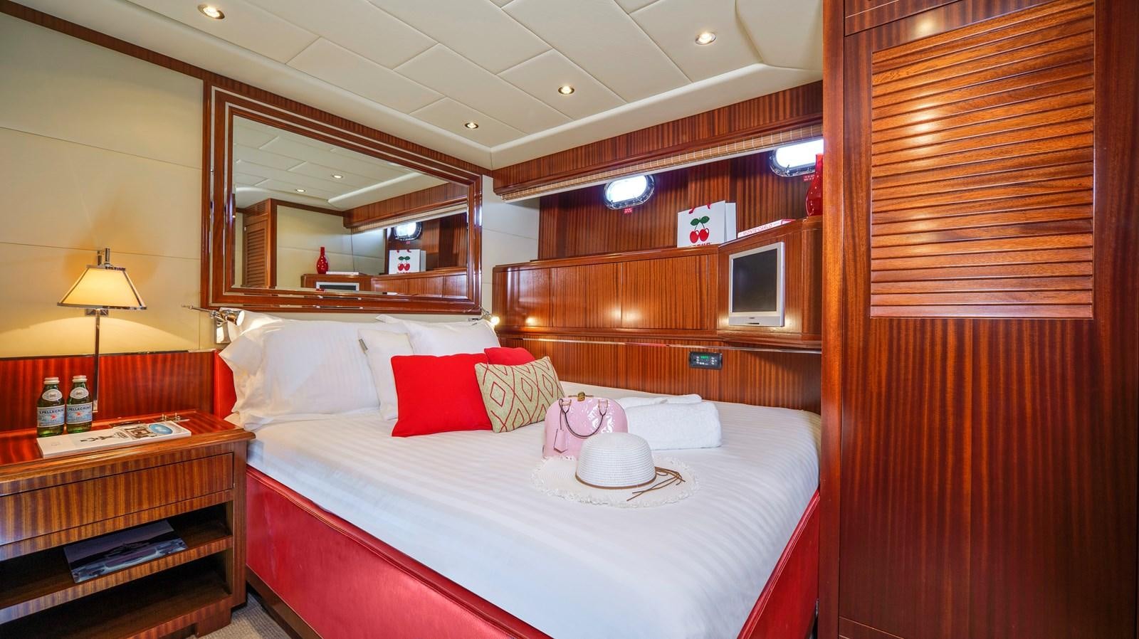 a bed with a white sheet and pillows aboard VANISH Yacht for Sale
