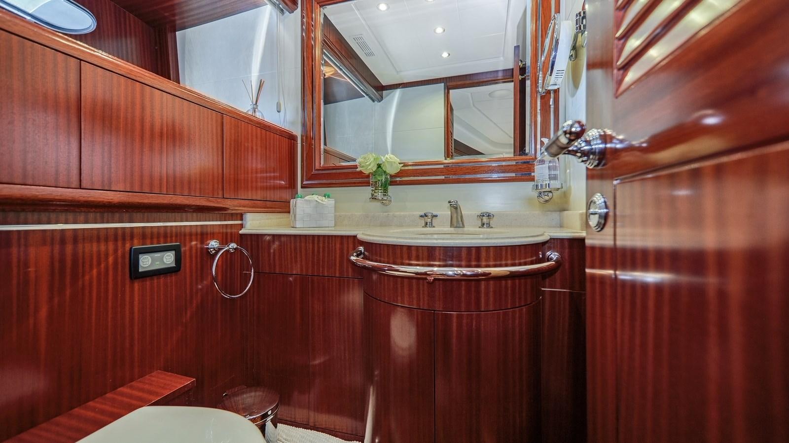 a bathroom with a sink and cabinets aboard VANISH Yacht for Sale