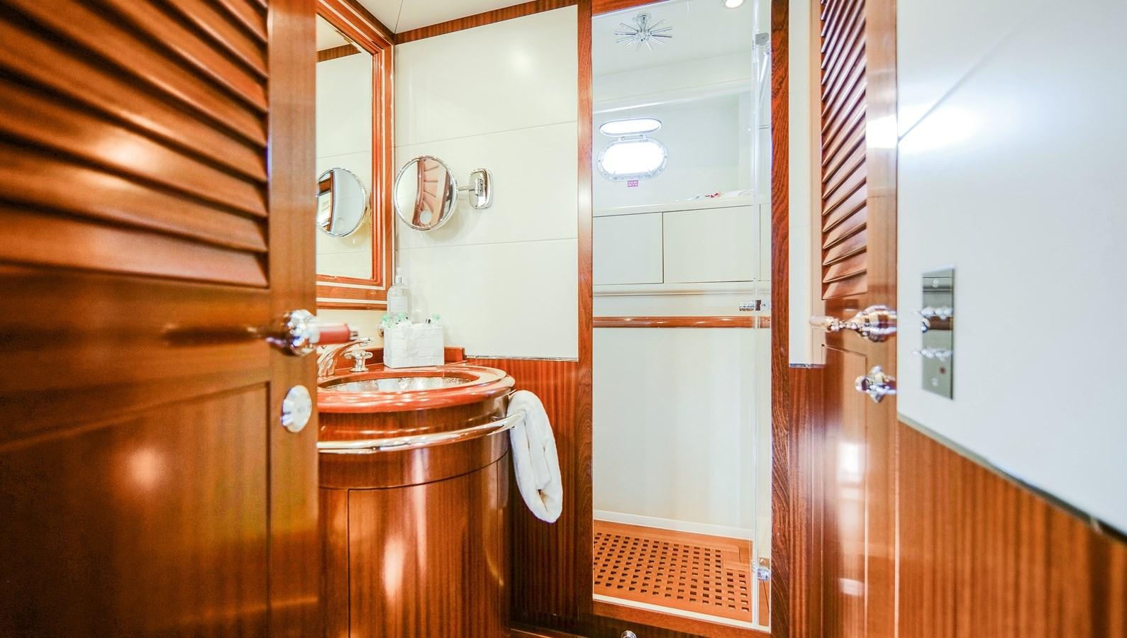 a small kitchen with a sink and cabinets aboard VANISH Yacht for Sale