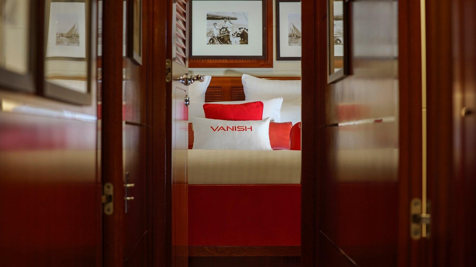 a red booth with a white and red flag on it aboard VANISH Yacht for Sale