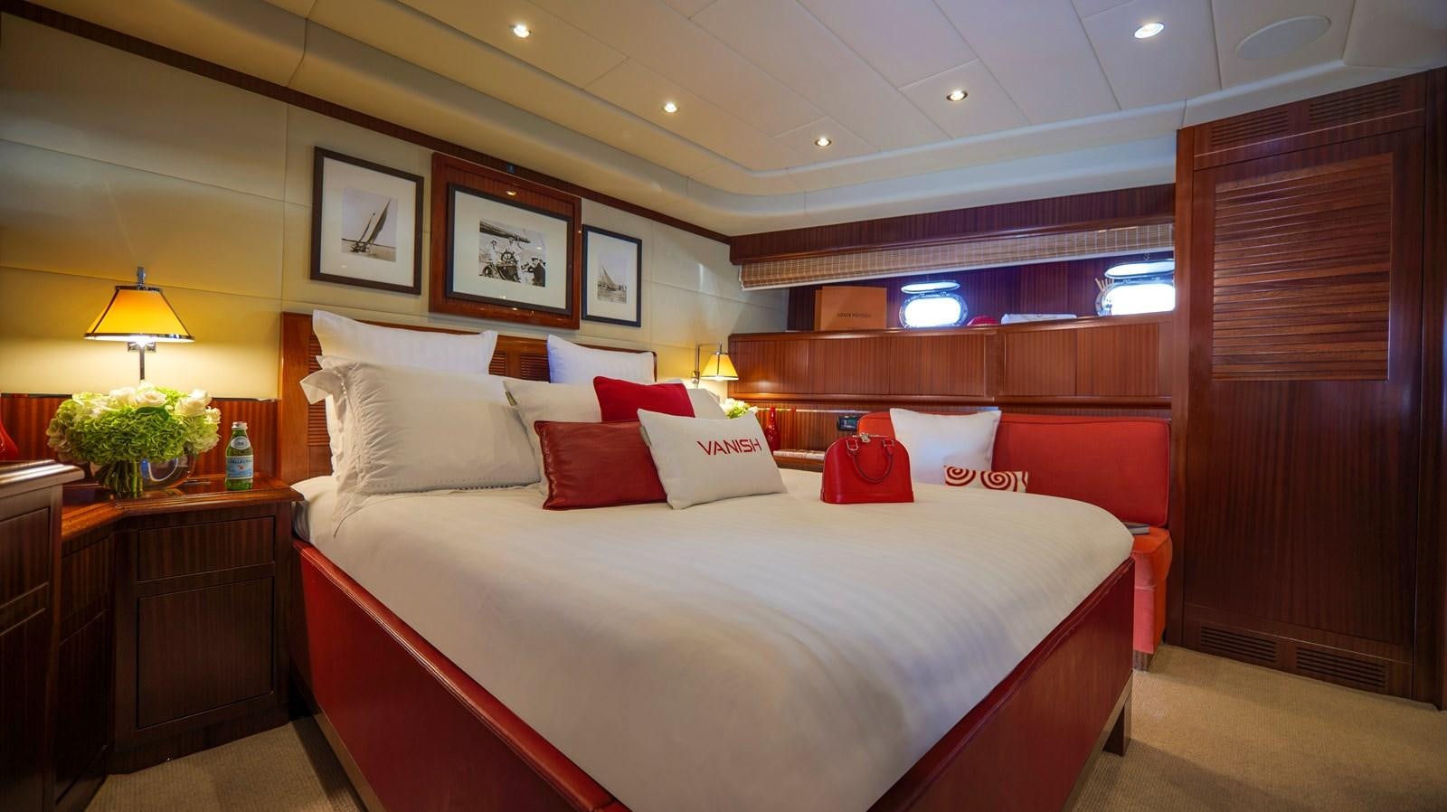 a hotel room with a bed and a desk aboard VANISH Yacht for Sale