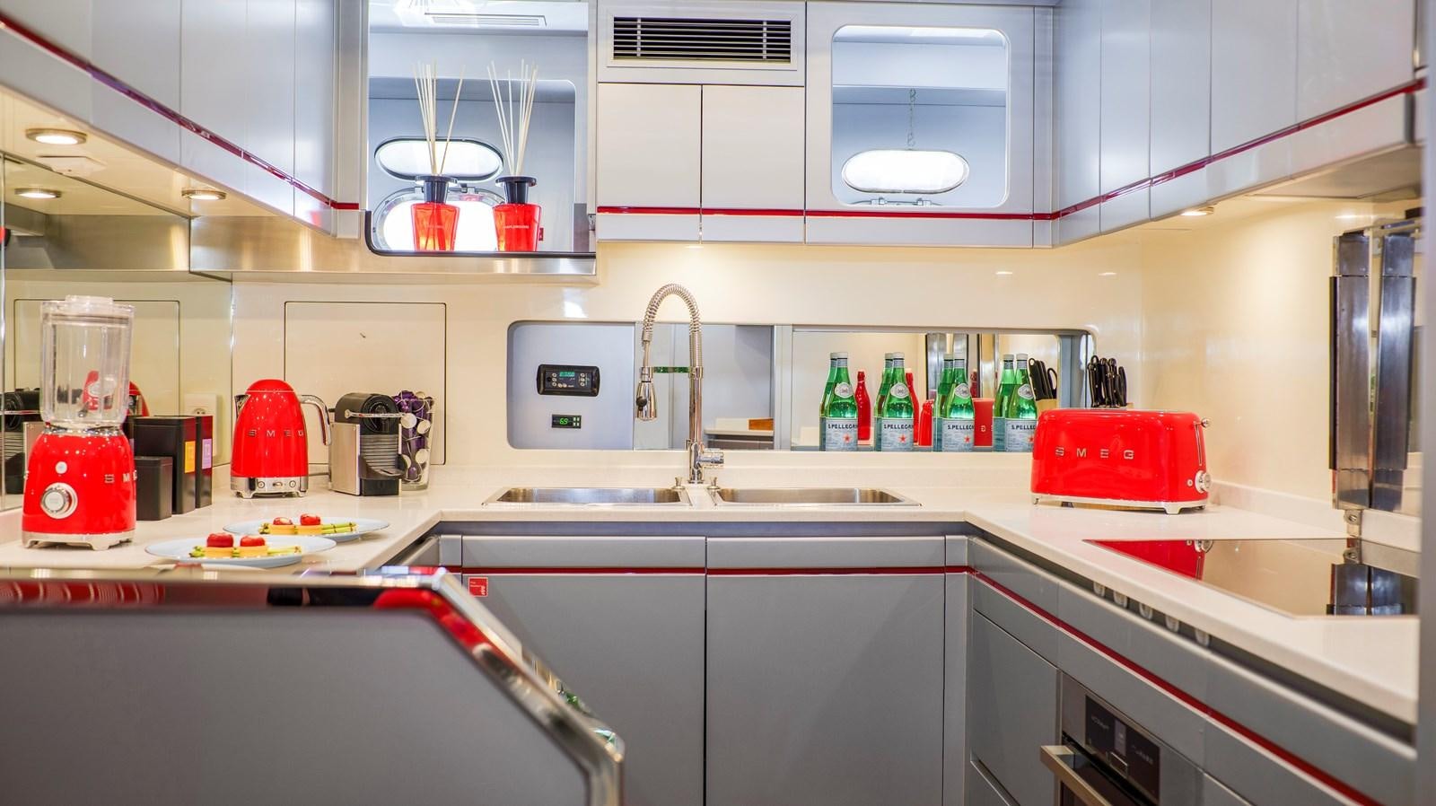 a kitchen with a red coffee maker aboard VANISH Yacht for Sale
