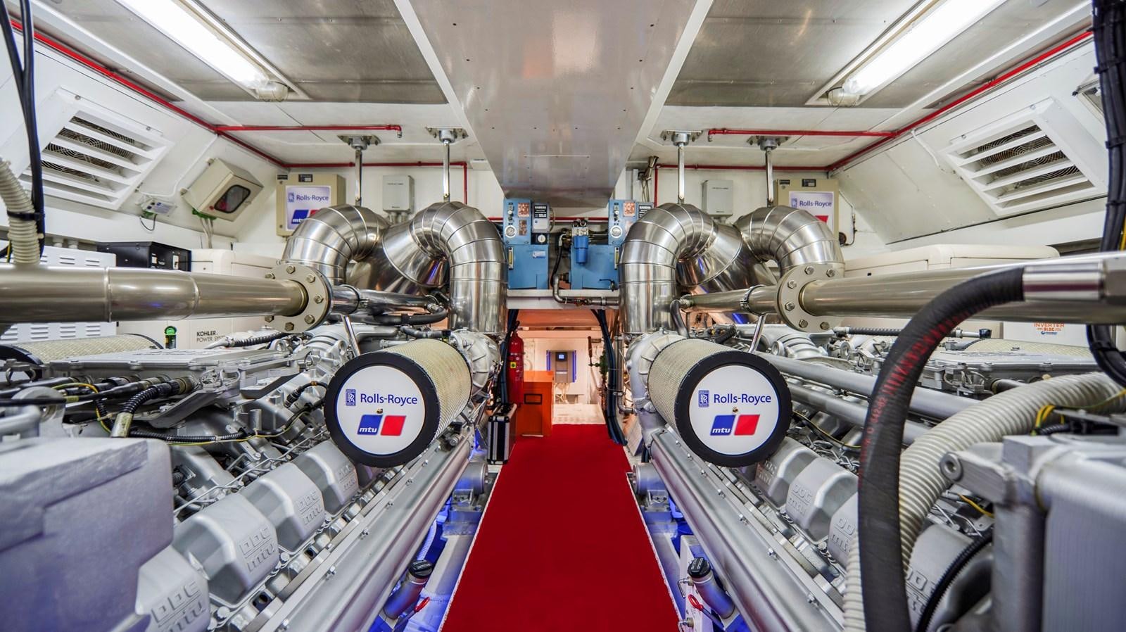 a room with many pipes and machinery aboard VANISH Yacht for Sale