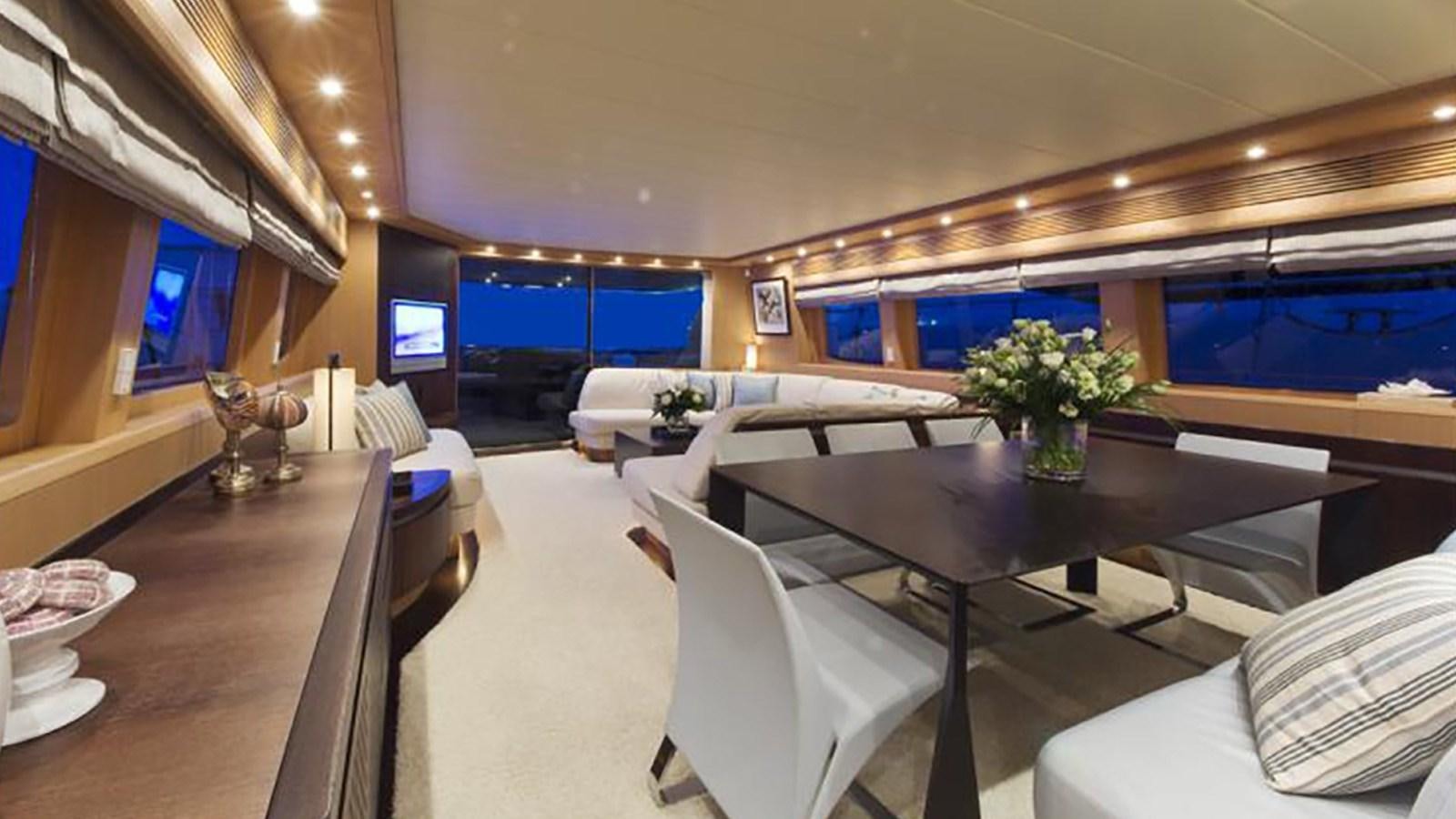 a room with a table and chairs aboard ASHA Yacht for Sale