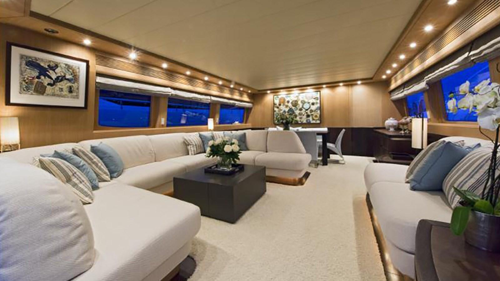 a living room with white couches aboard ASHA Yacht for Sale