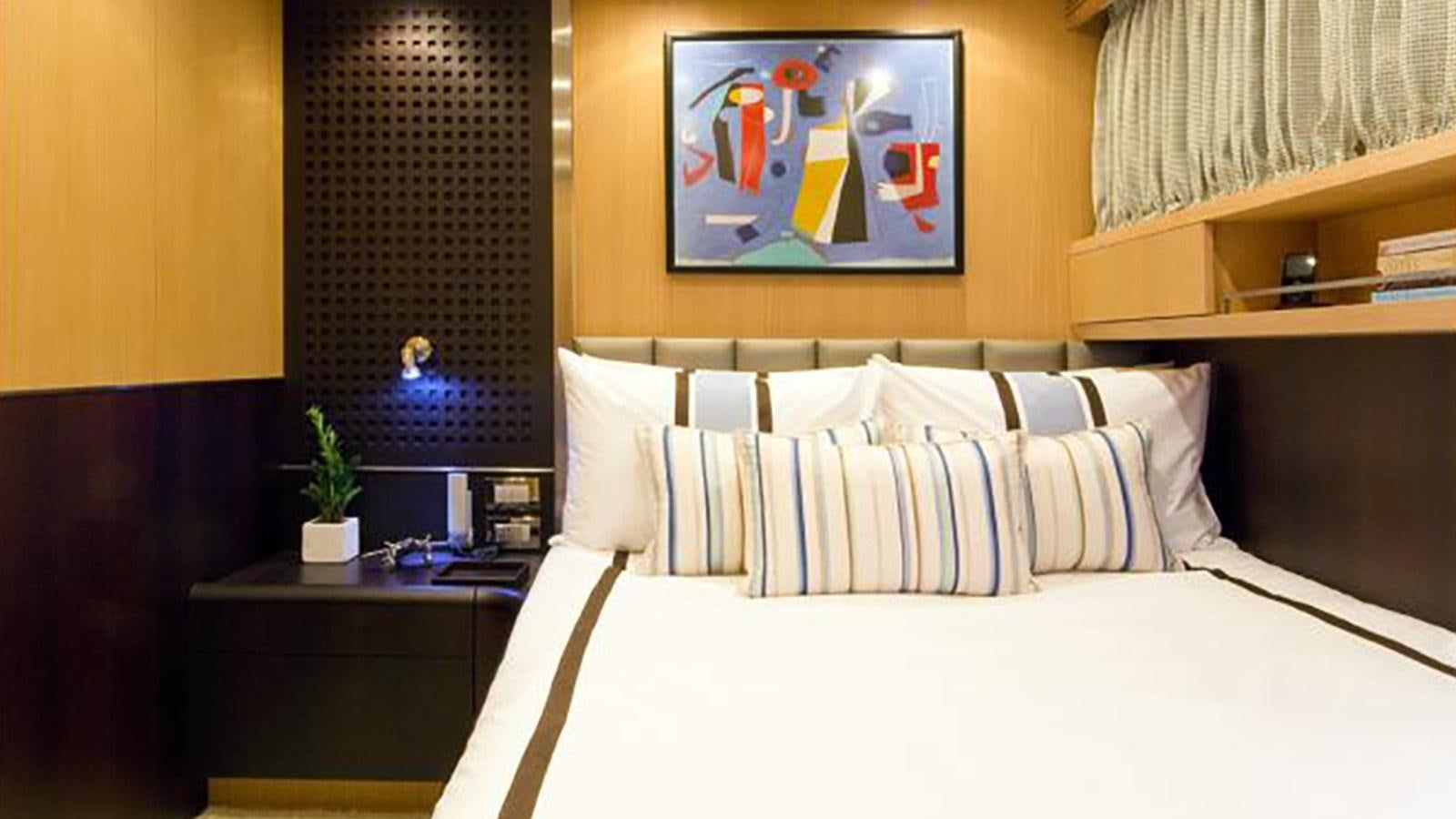 a bed with white sheets aboard ASHA Yacht for Sale