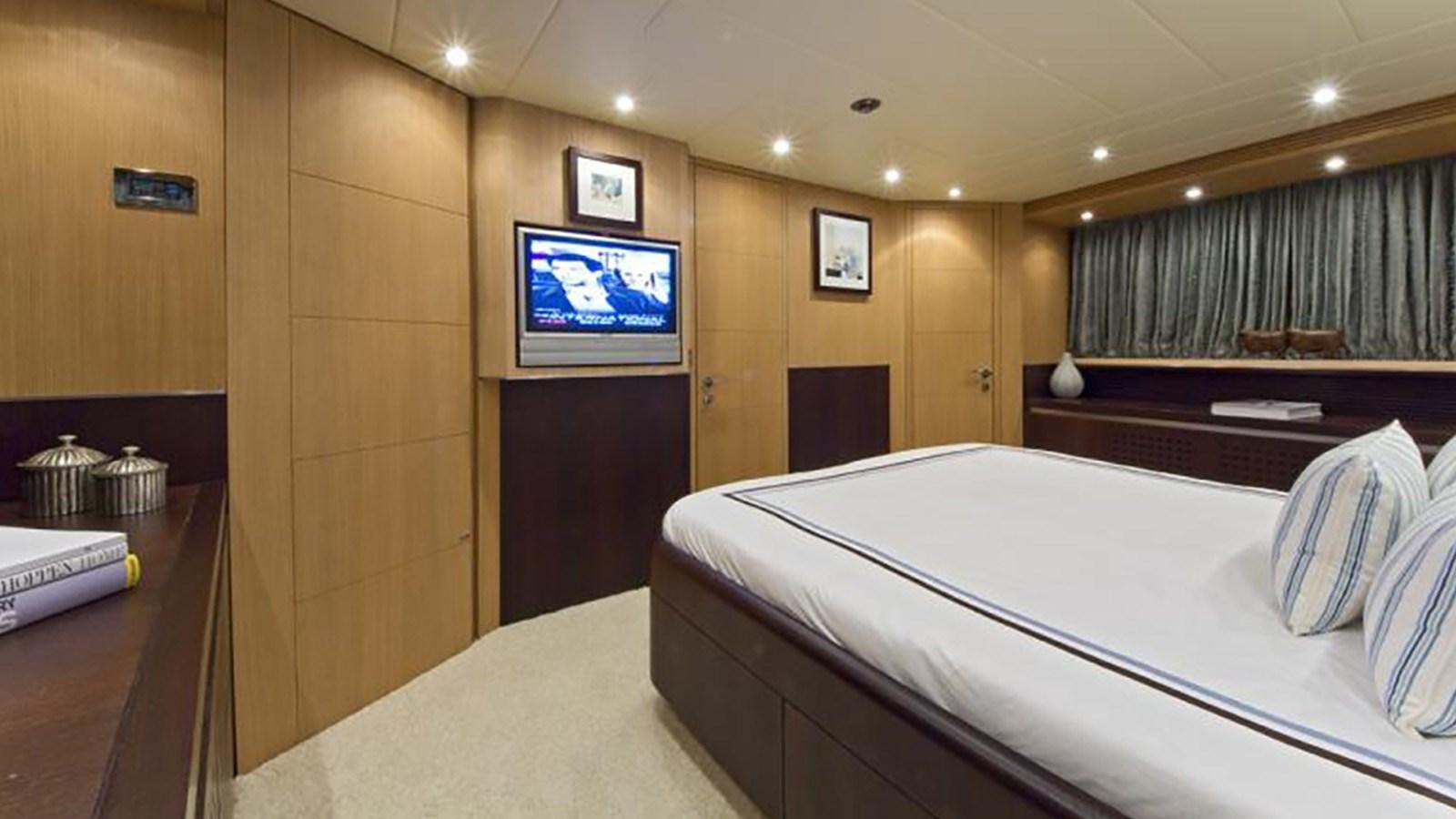 a room with a bed and a tv on the wall aboard ASHA Yacht for Sale