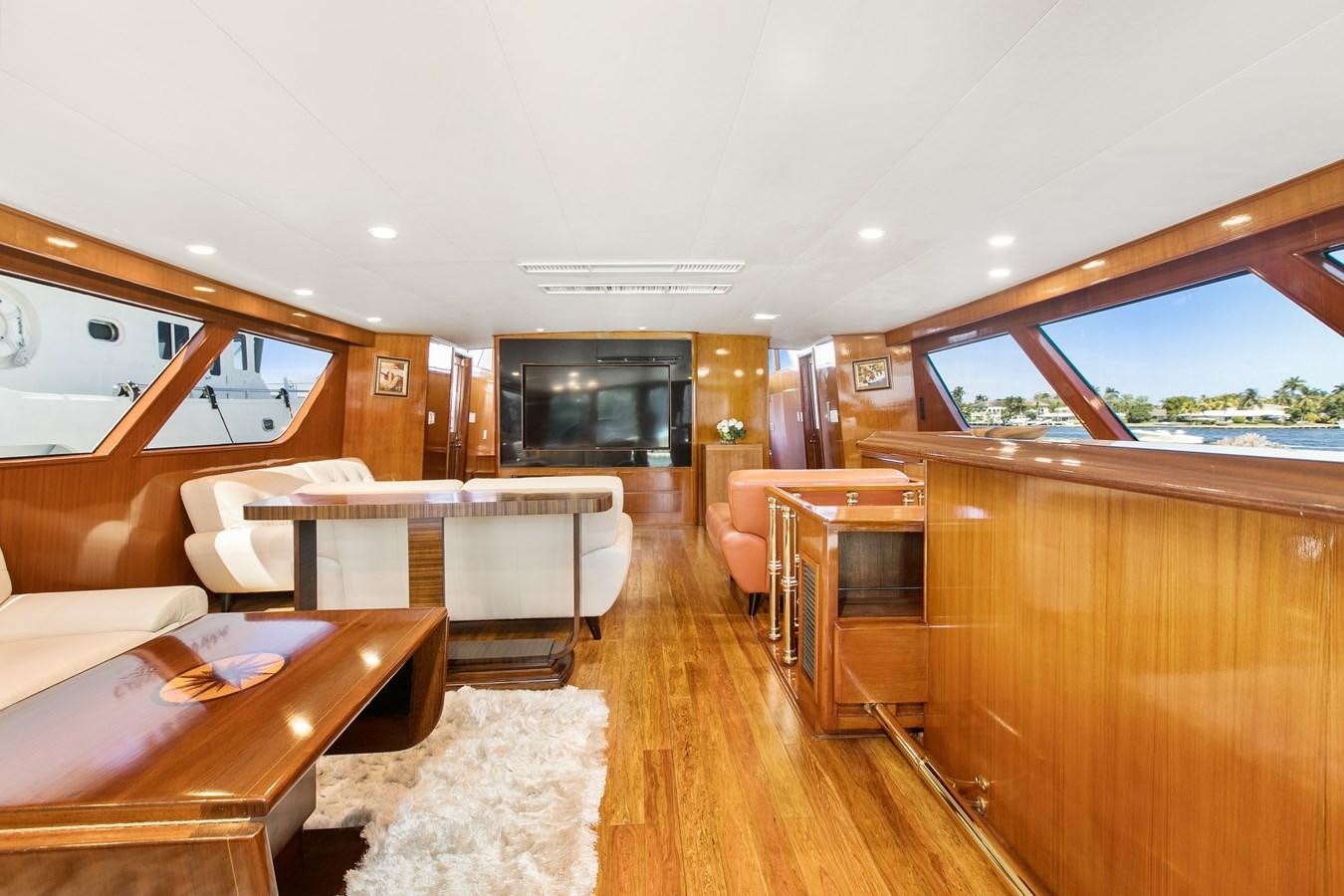 a large room with a table and chairs aboard TRES HERMANOS VI Yacht for Sale