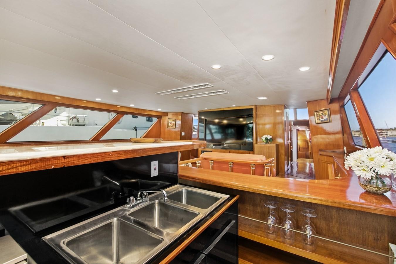 a kitchen with wooden cabinets aboard TRES HERMANOS VI Yacht for Sale