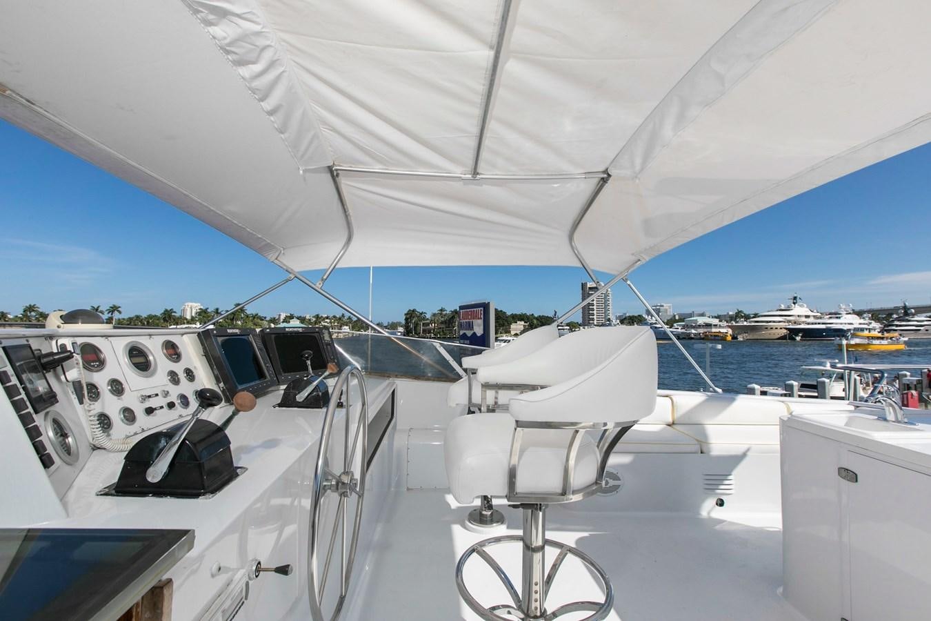 a boat with a chair on the deck aboard TRES HERMANOS VI Yacht for Sale