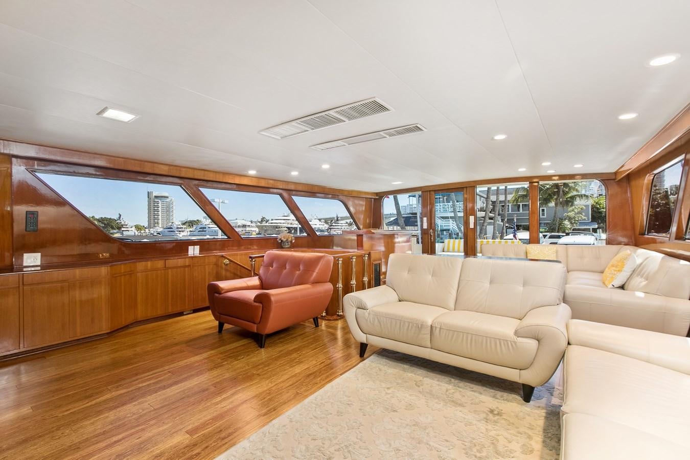 a living room with a wood floor aboard TRES HERMANOS VI Yacht for Sale