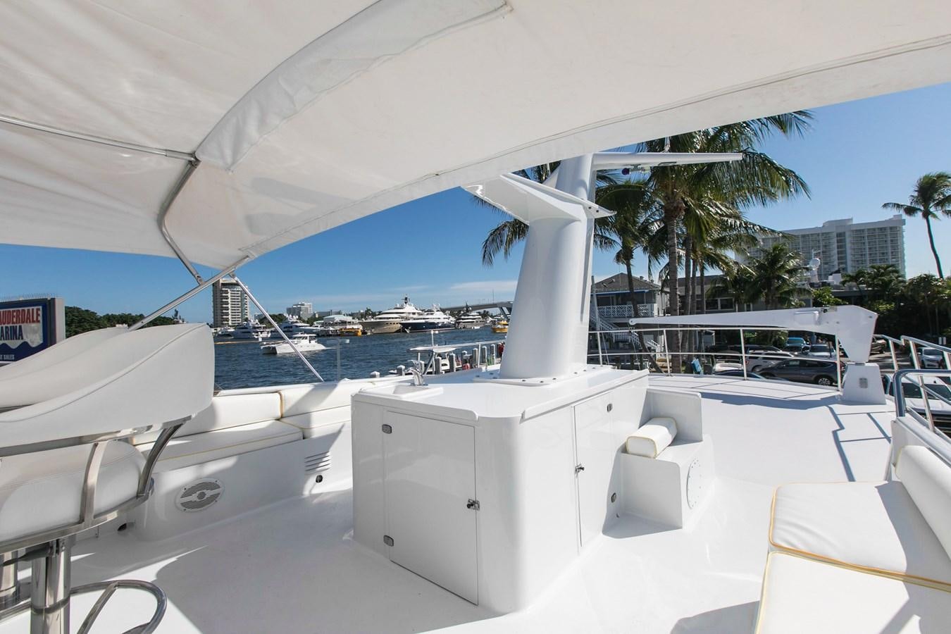 a white boat on a beach aboard TRES HERMANOS VI Yacht for Sale