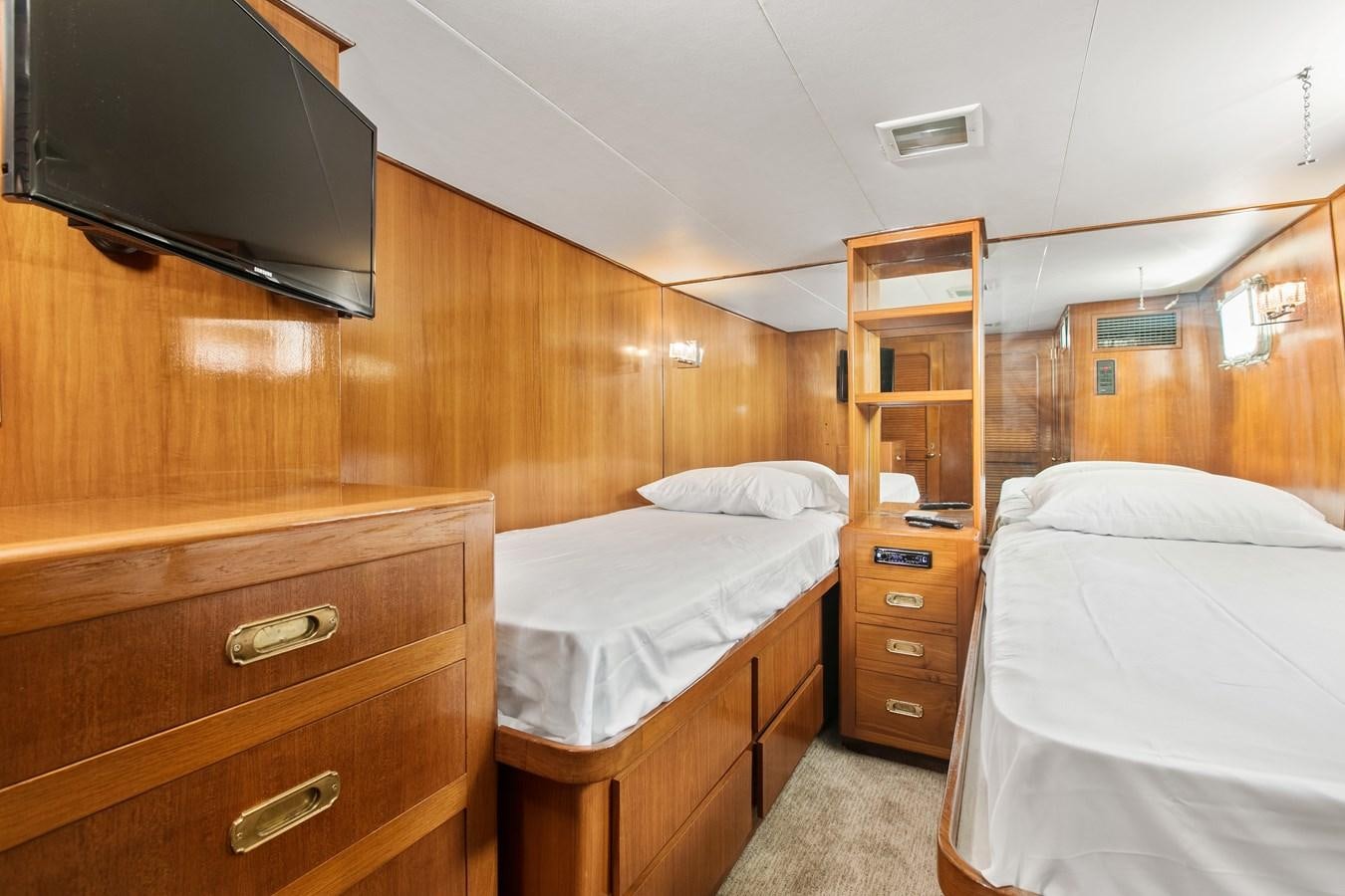 a room with a bed and a television aboard TRES HERMANOS VI Yacht for Sale