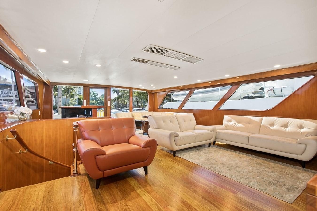 a living room with a wood floor aboard TRES HERMANOS VI Yacht for Sale