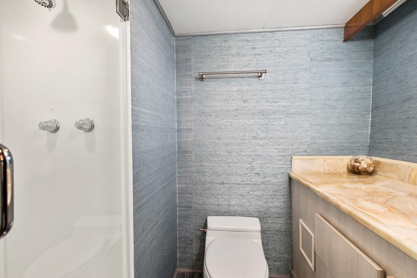 a bathroom with a toilet and a sink aboard TRES HERMANOS VI Yacht for Sale