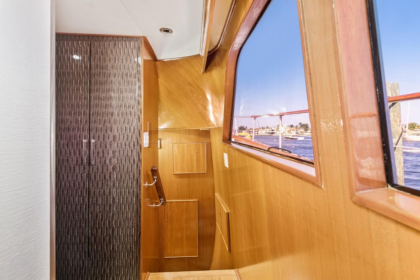a wooden door with a view of a city below aboard TRES HERMANOS VI Yacht for Sale