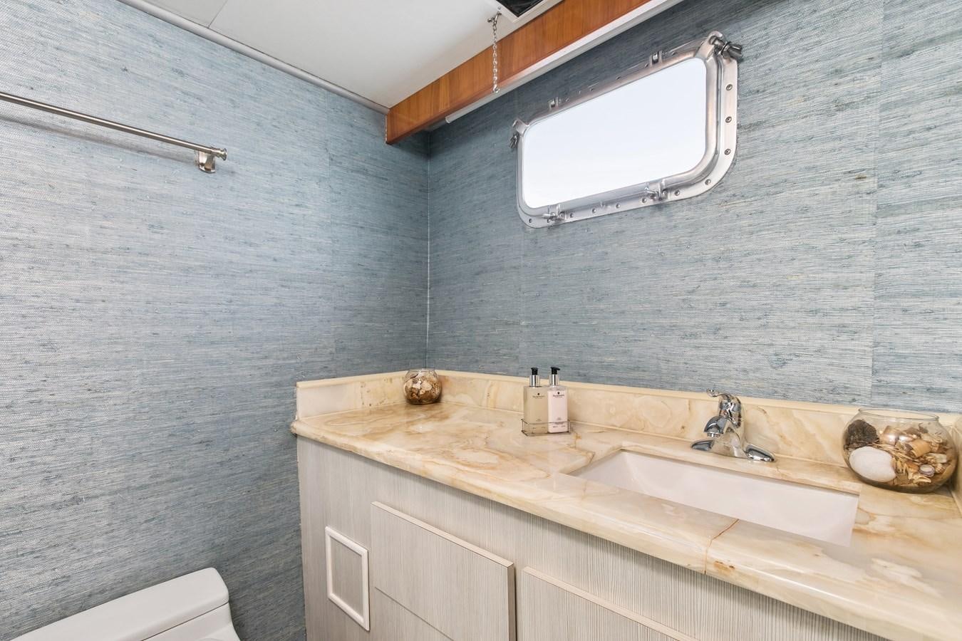a bathroom with a sink and a mirror aboard TRES HERMANOS VI Yacht for Sale