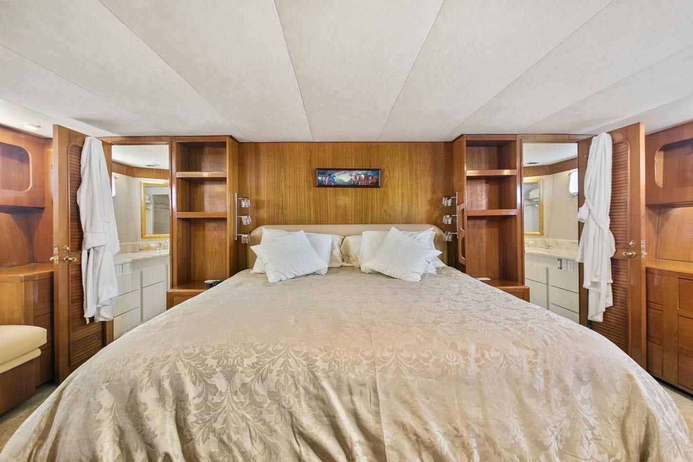 a bed with white sheets aboard TRES HERMANOS VI Yacht for Sale