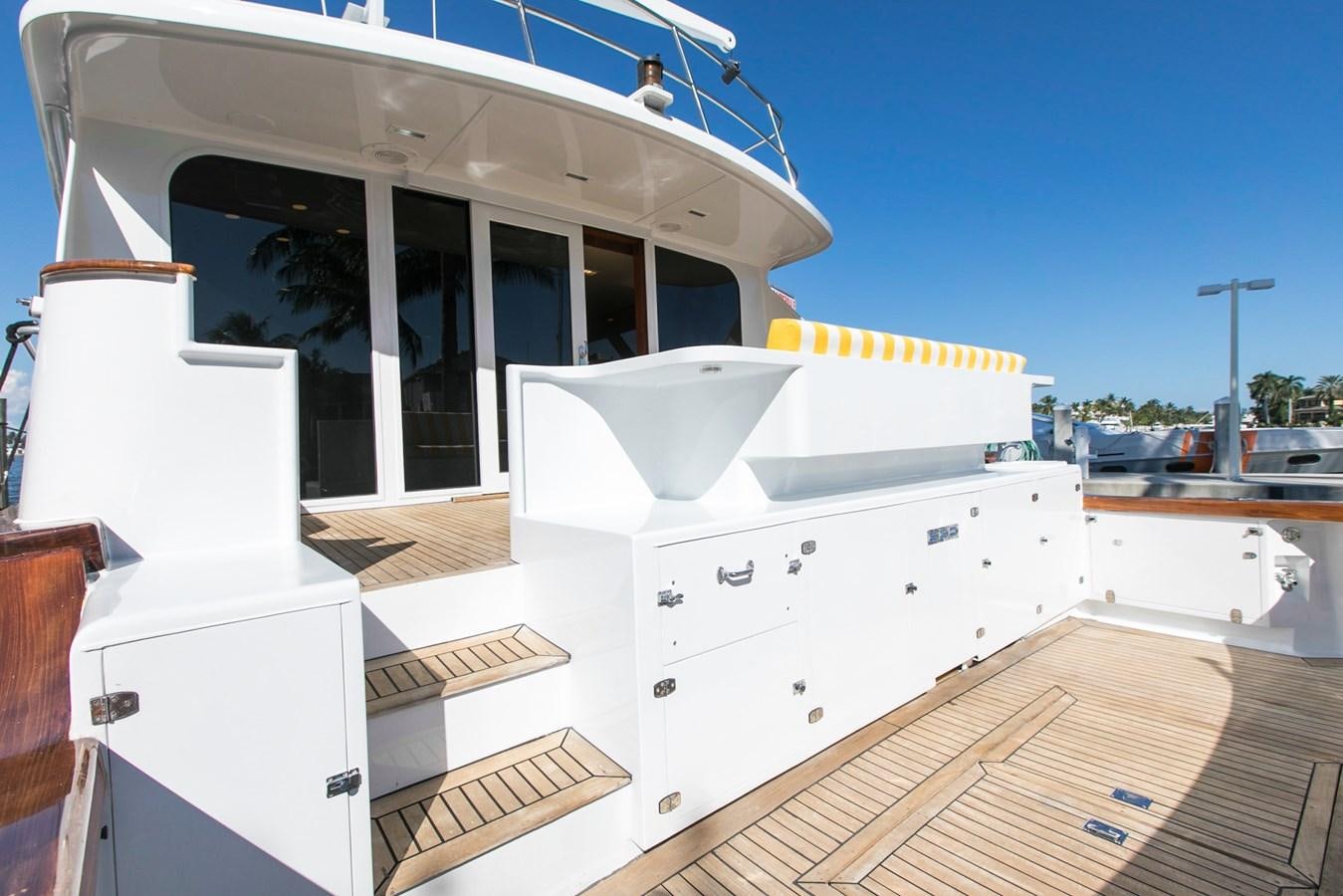 a white boat on a deck aboard TRES HERMANOS VI Yacht for Sale